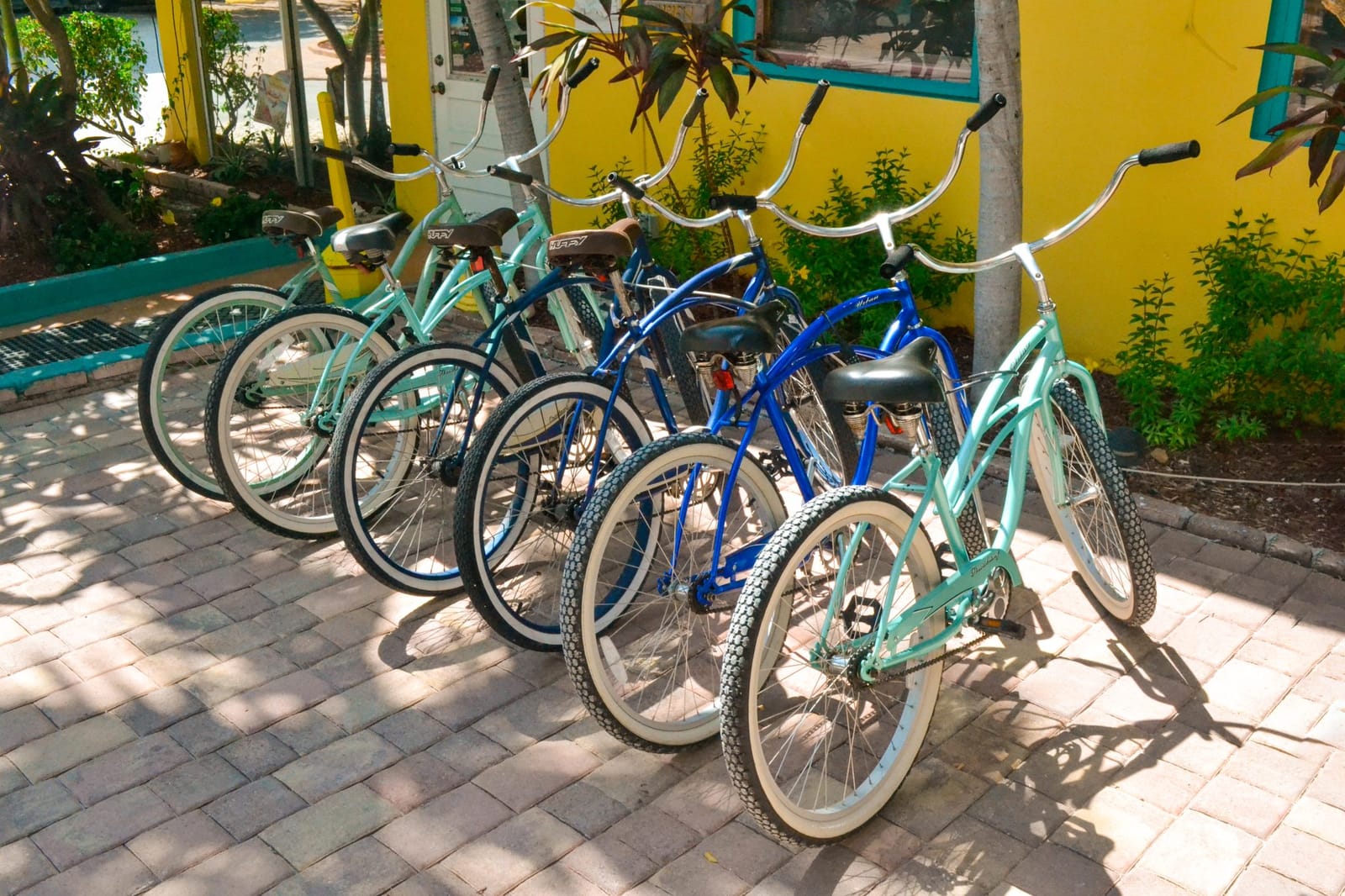 A row of blue and aqua beach cruiser bikes in the Florida Keys